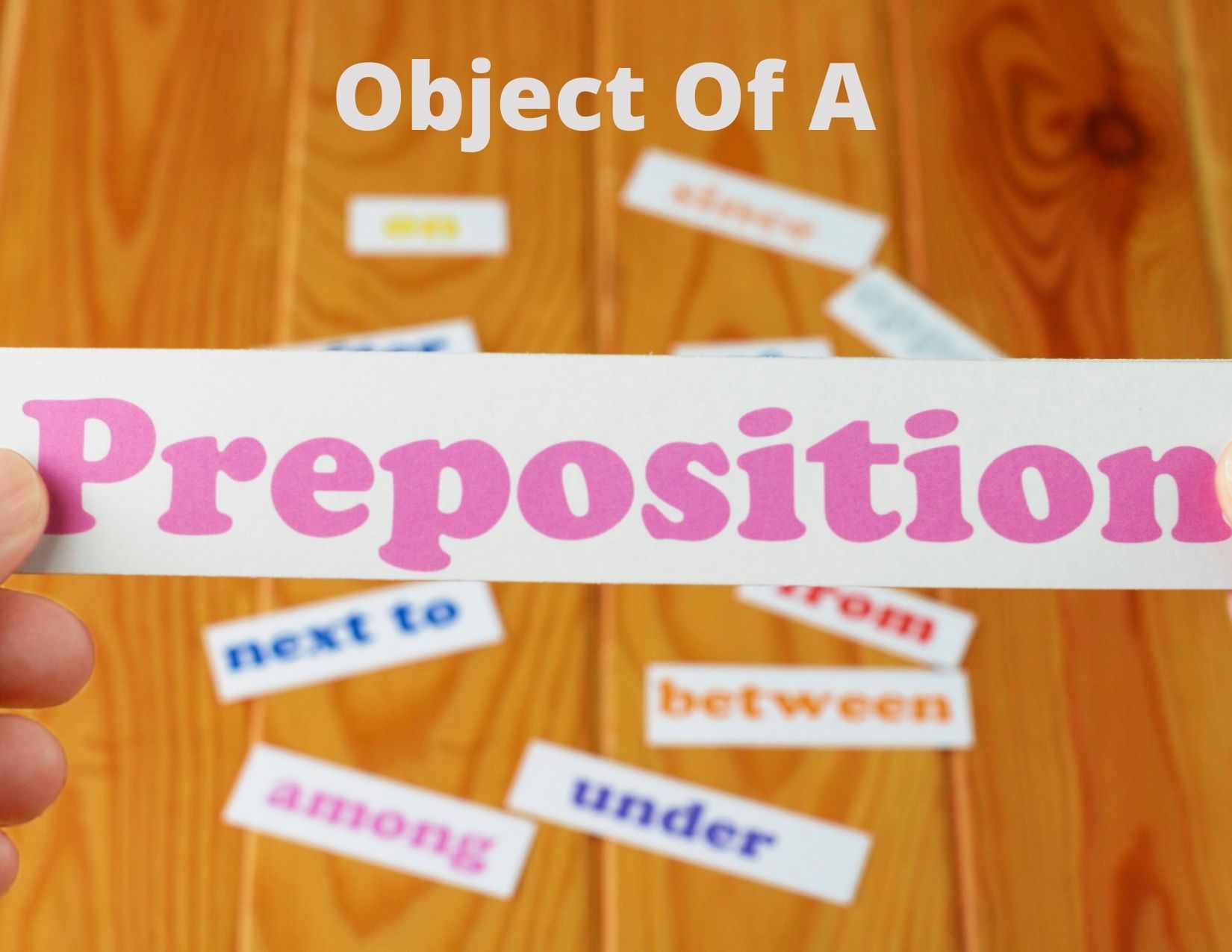 a graphic with scattered pieces of papers with various prepositions, along with the words "Object of a Preposition"