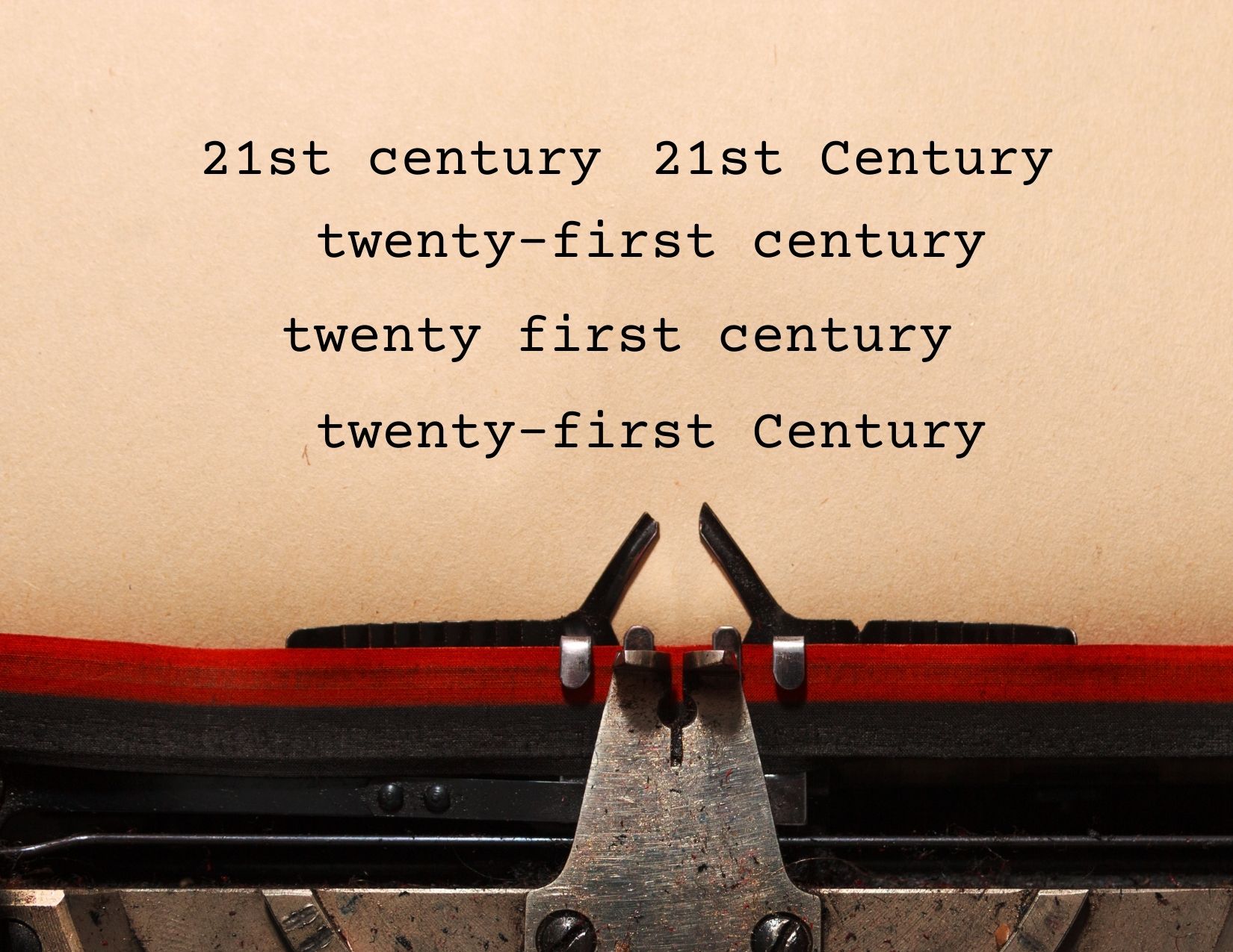A typewriter with a page that featured various variations of spelling "twenty first century" with some being capitalized and hyphenated