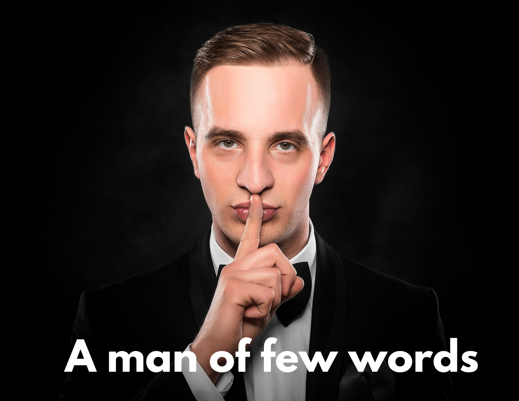 A picture of a man with his lips up to his lips with the words "A man of few words"