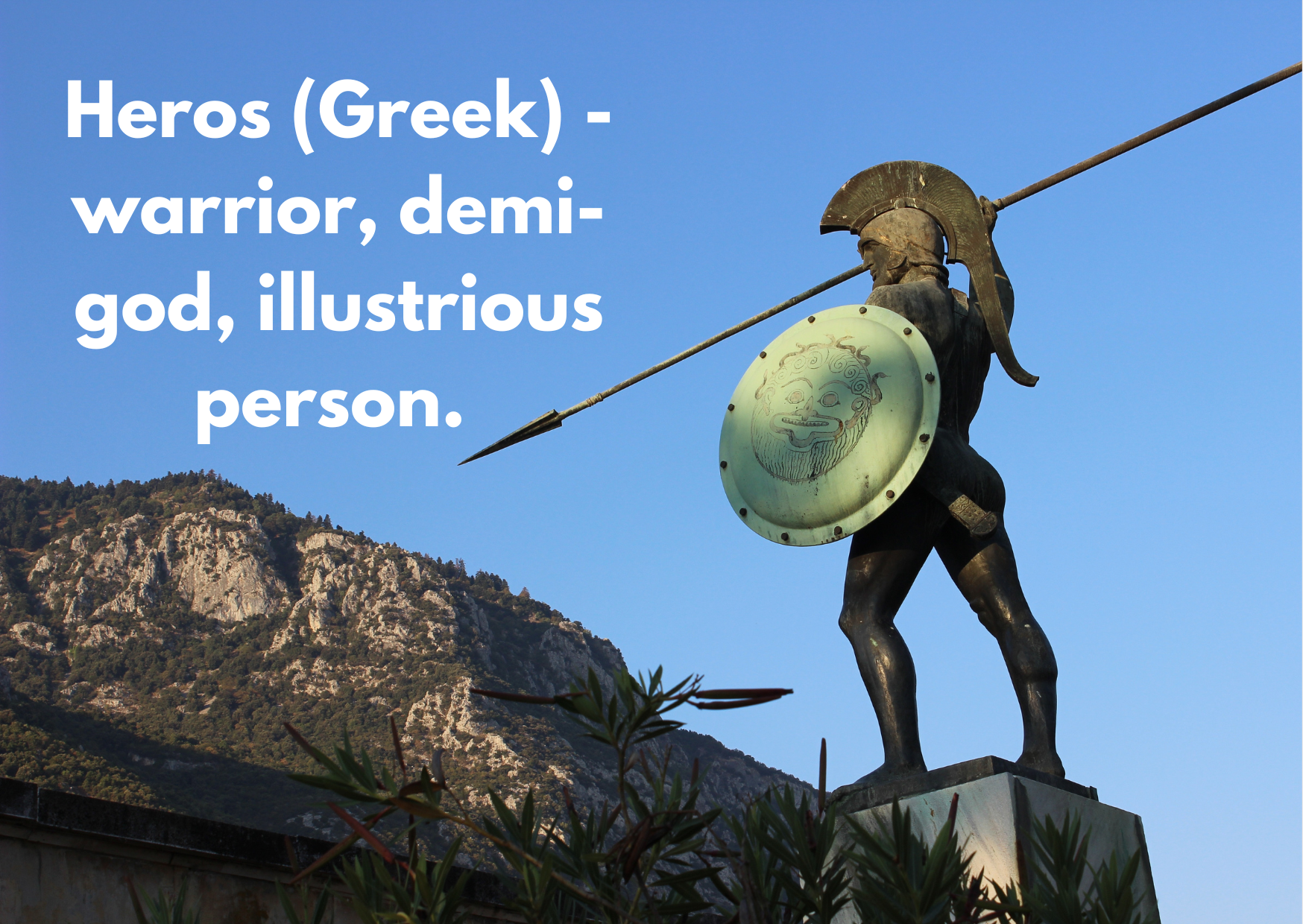 A stature of an Ancient Greek soldier with a spear and a caption explaining the Greek word "Heros" as "a warrior, demi-god, illustrious person"